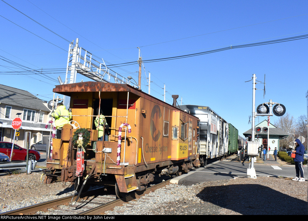 Chessie Caboose # 904059 on the rear of the train as it passes the restored Hawthorne Susquehanna Station where the stop for collection of toys was supposed to have been.